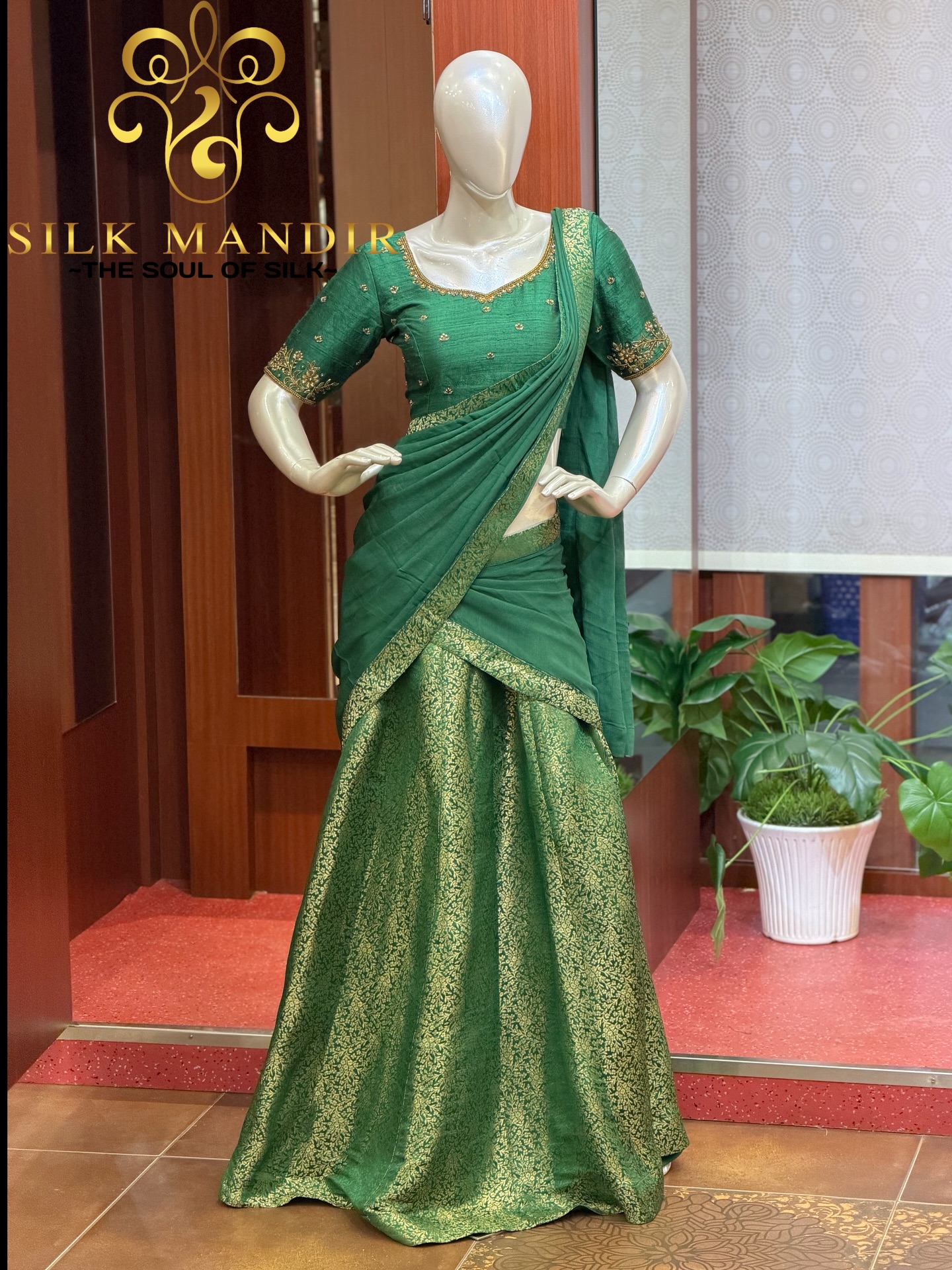 Emerald green half-saree on a mannequin