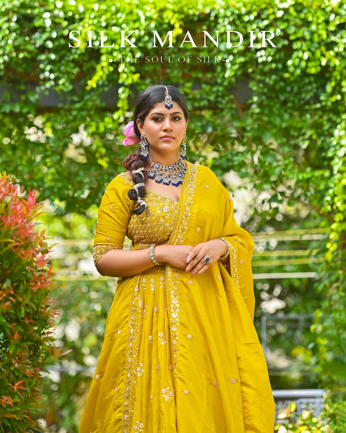 A woman in mustard lehenga among foliage