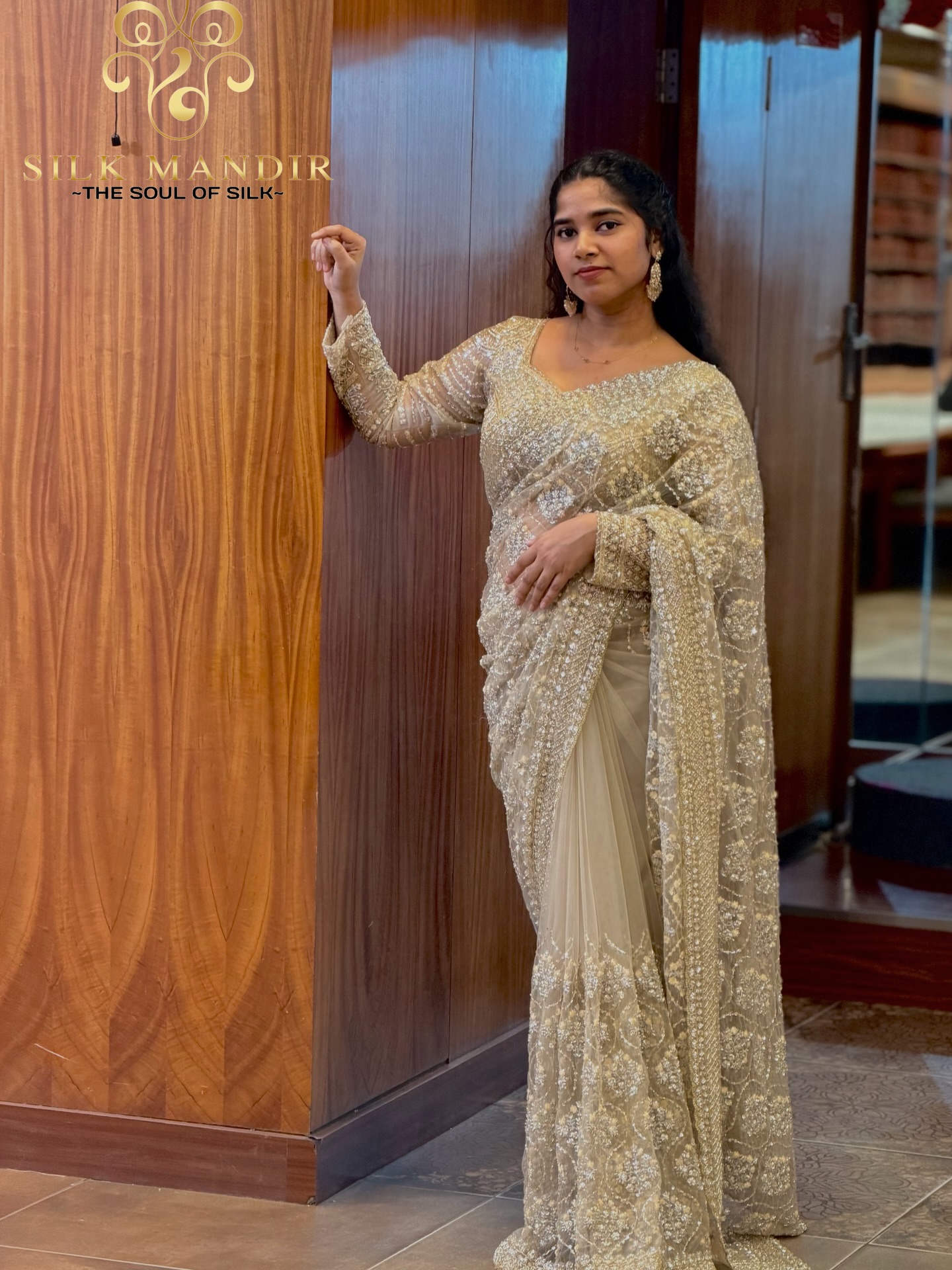 Cream pearl-embroidered saree on a model