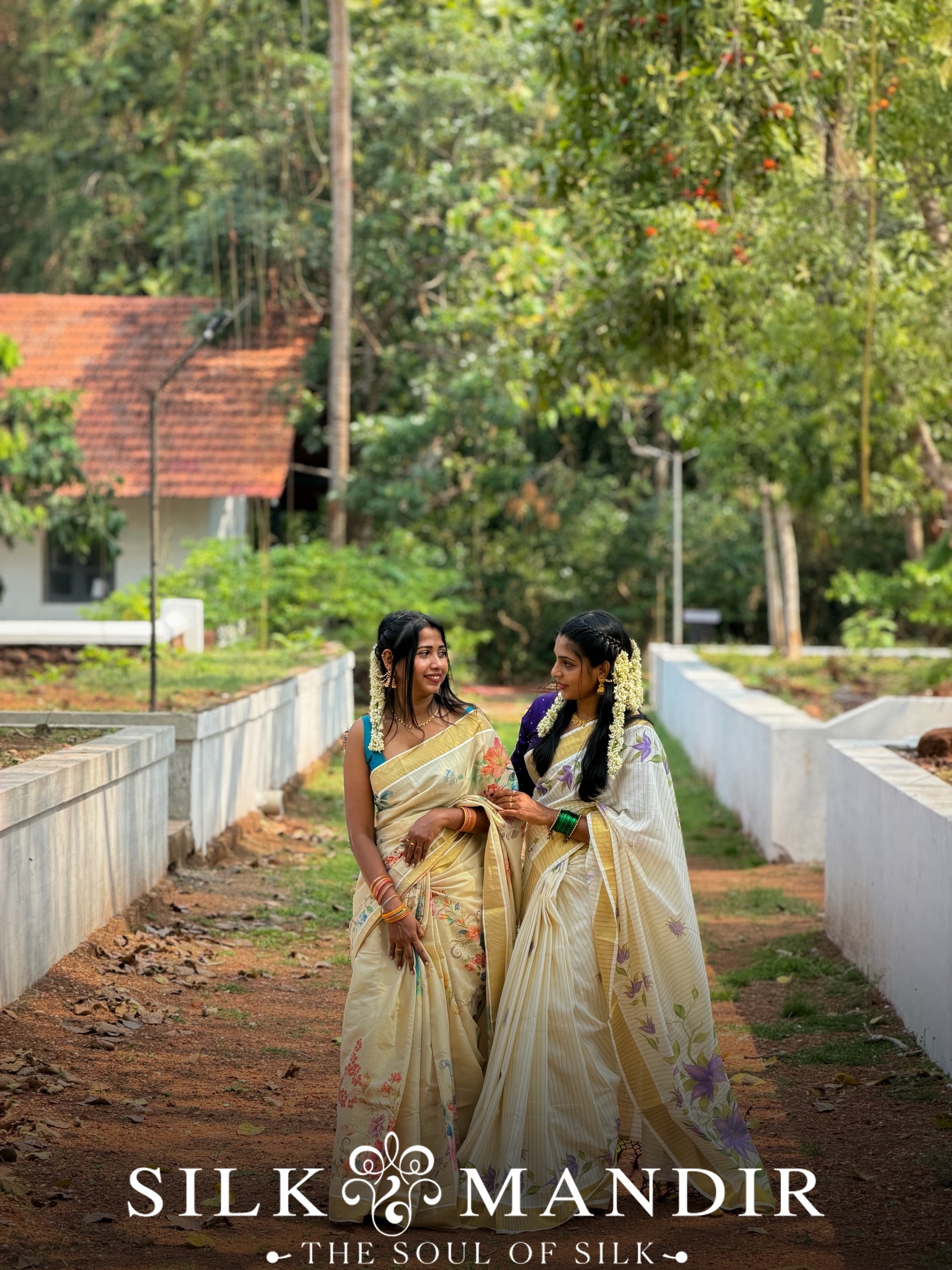 Two friends in Kerala kasavu walking down a village lane